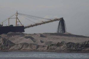 Heavy machineries are seen at the reclaimed area in Manila Bay in Pasay City, as they flatten the mounds of sand dredged from parts of the bay. PHOTO BY J. GERARD SEGUIA