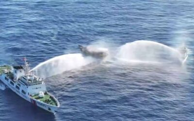 In this frame grab from aerial video footage taken on March 5, 2024 and released by the Philippine Coast Guard (PCG), Chinese Coast Guard ships (L and R) deploy water cannons at the Philippine military-chartered civilian boat Unaizah May 4 (C) during its supply mission near Second Thomas Shoal in the disputed South China Sea. The Philippines said on March 5 that China Coast Guard vessels caused two collisions with Philippine vessels and water cannoned a boat, leaving four crew injured during a resupply mission in the South China Sea. (Photo by Handout / Philippine Coast Guard (PCG) / AFP)
