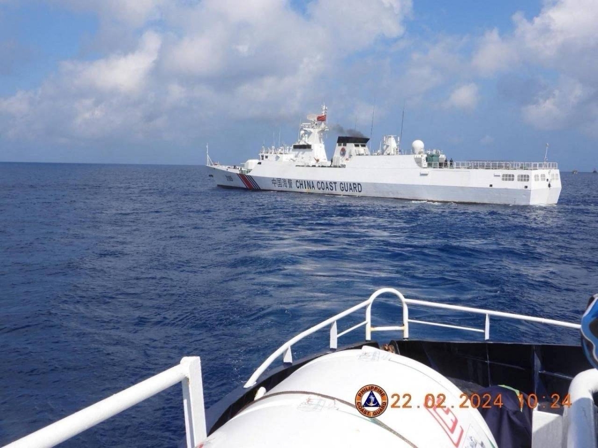 This handout photo taken on February 22, 2024 and received on February 25, 2024 from the Philippine Coast Guard shows a China Coast Guard vessel sailing near the BRP Datu Sanday during their mission to bring supplies to fishermen near the China-controlled Scarborough Shoal in the disputed South China Sea. AFP PHOTO / Philippine Coast Guard