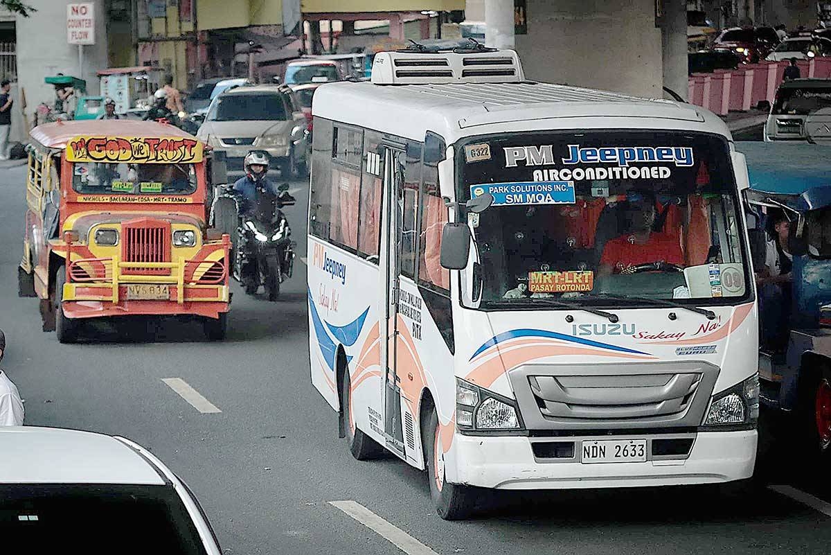 Modern and traditional jeepneys are seen side by side as they compete for passengers in Pasay City, Thursday. The Supreme Court has denied the petition of some transport groups in challenging the PUV Modernization Program. PHOTOS BY J. GERARD SEGUIA