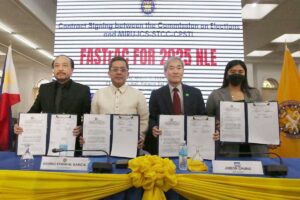 IT’S A DEAL Commission on Elections Chairman Erwin Garcia (second from left), Miru Systems President Jinbok Chung, Commissioner Rey Bulay and Miru’s Valerie Ann Manahan hold copies of the signed contract on Monday, March 11, 2024. Photo by Rene H. Dilan