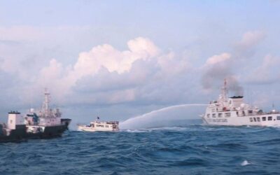 Chinese Official Warns of Dangerous Implications of Philippine Maritime Zones Act This handout photo taken and released on December 10, 2023 by the Philippine Coast Guard (PCG) shows a China Coast Guard vessel (R) using water cannon against the M/L Kalayaan chartered supply boat (C) during a mission to deliver provisions at Second Thomas Shoal in disputed waters of the South China Sea. A Philippine boat was 'rammed' by a Chinese coast guard ship during a resupply mission on December 10, the Philippine coast guard said, in the latest such confrontation in the disputed South China Sea. The Philippine Coast Guard also said a Chinese ship 'water cannoned' three Philippine vessels involved in the resupply mission, causing 'serious engine damage' to one of the boats. Handout / Philippine Coast Guard (PCG) / AFP