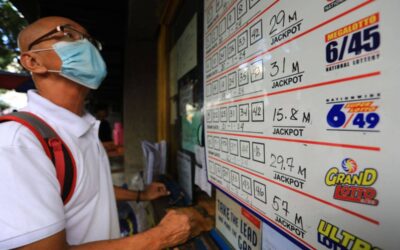 LOTTO FEVER A man looks at lotto prizes before placing his bet at a lotto outlet in Manila on Monday, Jan. 22, 2024. A lone bettor bagged the P698.8-million jackpot in the Grand Lotto 6/55 draw on January 18. PHOTO BY MIKE ALQUINTO