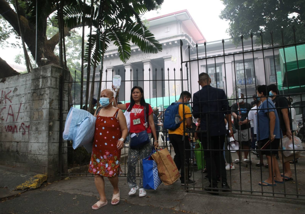 The nurses evacuated their patients due to a fire at the Philippine General Hospital (PGH) Main Building on Wednesday, which reached the 3rd alarm. The said fire continues to be extinguished. PHOTO BY: RENE H. DILAN
