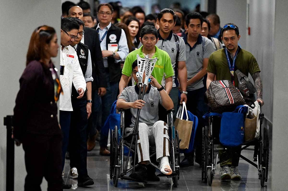 Filipino crew survivors (wearing gray shirts) of the Huthi missile attack on a commercial ship, arrives at the airport in Pasay, Metro Manila on March 12, 2024. Two Filipino crew members were among those killed in a missile attack by Yemen's Huthi rebels on a ship in the Gulf of Aden, the Philippine government said Thursday.
JAM STA ROSA / AFP