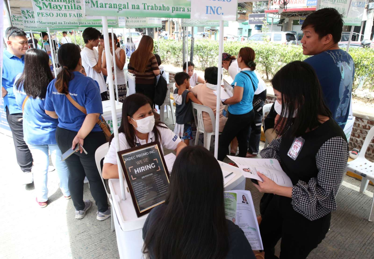 Residents line up at a job fair in Manila on Wednesday, March 13, 2024, as part of the city's 'Kalinga sa Maynila' program. PHOTOS BY RENE DILAN