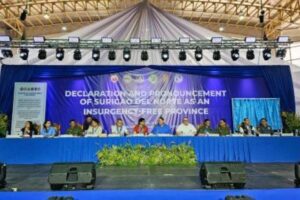 PEACE. Interior and Local Government Secretary Benjamin Abalos Jr. and Defense Secretary Gilberto Teodoro Jr. (6th and 7th from left) lead the declaration of Surigao del Norte province as insurgency-free on Friday (March 15, 2024). Thirty former rebels also recited oaths of allegiance to the government. (Photo courtesy of PIA-Surigao del Norte)
