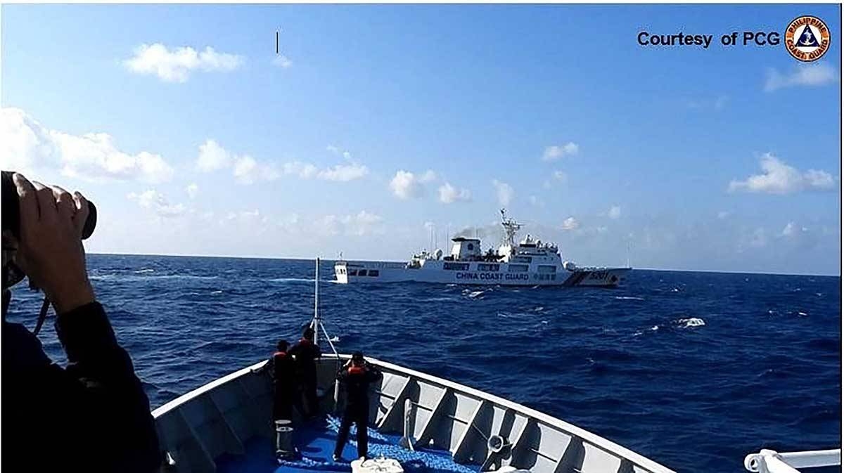 In this handout frame grab video footage on March 21, 2024 and received from Philippine Coast Guard (PCG) on March 22, shows a Chinese Coast Guard ship (top) maneuvering past a Philippine Coast Guard ship near Sandy Cay reef, near the Philippine-held Thitu Island in Spratly Islands, in the disputed South China Sea. The Philippine Coast Guard on March 22 accused a Chinese vessel of 'dangerous maneuvers' as it attempted to block Filipino scientists from reaching a reef in the South China Sea.
Handout / Philippine Coast Guard (PCG) / AFPAF