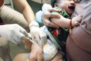 ‘THAT HURTS’ A health worker injects a pentavalent vaccine on an infant at a health center in Quezon City on Friday, March 22, 2024. The Quezon City government declared an outbreak of pertussis or whooping cough after logging 23 cases, including four deaths, mostly infants from 22 to 60 days old. PHOTO BY ISMAEL DE JUAN