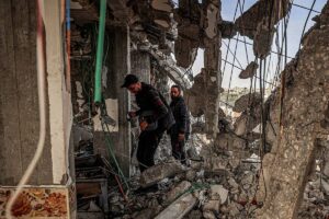 People inspect damage to a building that was hit overnight during Israeli bombardment in Rafah in the southern Gaza Strip on March 26, 2024 amid the ongoing conflict in the Palestinian territory between Israel and the militant group Hamas. SAID KHATIB / AFP