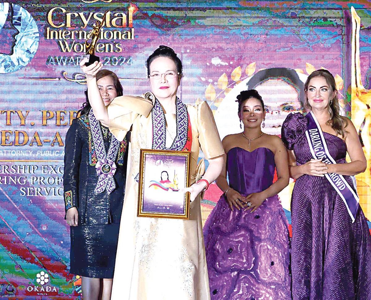 Public Attorney’s Office chief Persida Rueda-Acosta accepts her trophy from Crystal International Women Award on Friday, March 22, 2024. CONTRIBUTED PHOTO