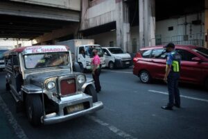 A Pasay City traffic enforcer and a Metropolitan Manila Development Authority (MMDA) personnel prevent traffic build-up along EDSA in Pasay City. PHOTOS BY J. GERARD SEGUIA