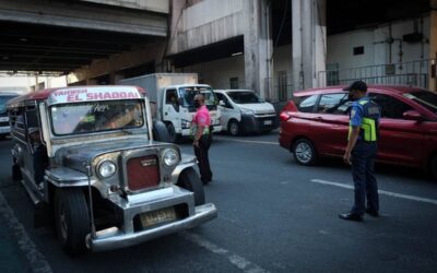 A Pasay City traffic enforcer and a Metropolitan Manila Development Authority (MMDA) personnel prevent traffic build-up along EDSA in Pasay City. PHOTOS BY J. GERARD SEGUIA