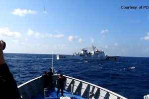 In this handout frame grab video footage on March 21, 2024 and received from Philippine Coast Guard (PCG) on March 22, shows a Chinese Coast Guard ship (top) maneouvering past a Philippine Coast Guard ship near Sandy Cay reef, near the Philippine-held Thitu Island in Spratly Islands, in the disputed South China Sea. The Philippine Coast Guard on March 22 accused a Chinese vessel of "dangerous manoeuvres" as it attempted to block Filipino scientists from reaching a reef in the South China Sea.
Handout / Philippine Coast Guard (PCG) / AFP