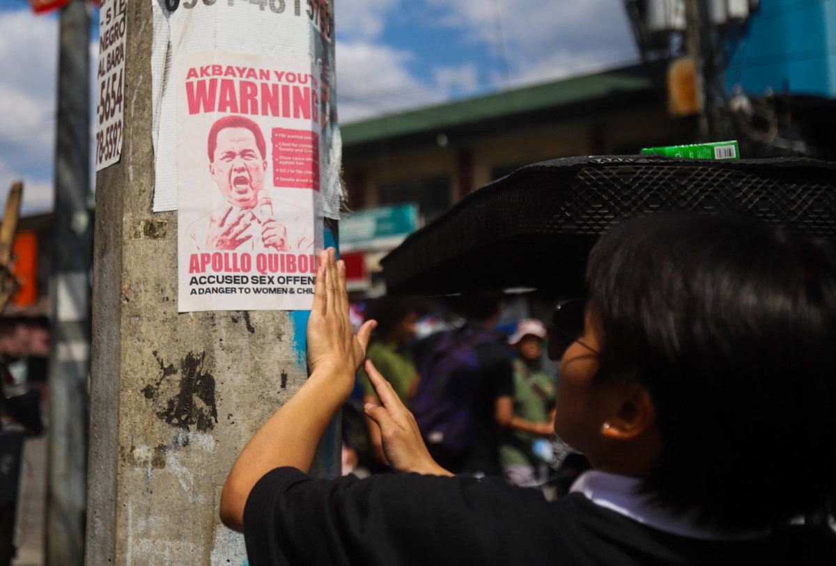 Members of Akbayan Youth put up posters calling for the arrest of Pastor Apollo Quiboloy in Quezon City on Monday, March 18, 2024. PHOTOS BY JOHN ORVEN VERDOTE