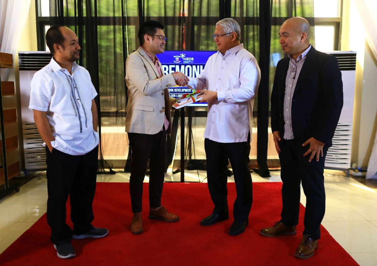 Cesar Gilbert Adriano, director of the National Library of the Philippines (NLP), receives books from The Manila Times Chairman and CEO and National Book Development Board (NBDB) Chairman Dante ‘Klink’ Ang 2nd at the NLP on Thursday, April 4, 2024. With them were Edgardo Quiros (left), assistant director National Library of the Philippines, and Anthony John Balisi of NBDB. The event also included a tour of the site where The Gallery and the Children's Library are being built. PHOTO BY MIKE ALQUINTO
