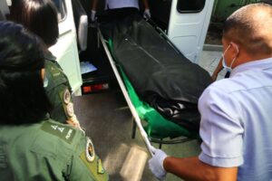 The bodies of two Philippine Navy pilots who died in a helicopter crash near the Cavite City Public Market during a training on Thursday, April 11, 2024 are carried onto a van as fellow soldiers watch. An investigation is underway to determine the cause of the accident. PHOTOS BY MIKE ALQUINTO