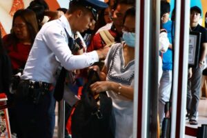 BACK IN THE CITY A security guard checks the bags of passengers returning to Manila after spending their Holy Week break in the provinces, at the Parañque Integrated Terminal Exchange in Parañaque City, on Monday, April 1, 2024. PHOTO BY MIKE ALQUINTO
