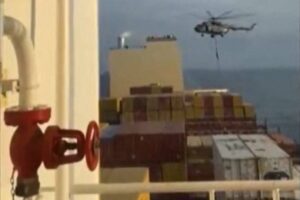 This image grab taken from a UGC video posted on social media on April 13, 2024 shows Iran's Revolutionary Guards rappelling down onto a container ship named, MSC Aries, near the Strait of Hormuz. Iran's Revolutionary Guards on Saturday seized a container ship "related to the Zionist regime (Israel) in the Gulf," state media reported, as tensions soar in the region. AFP PHOTO / XGTY