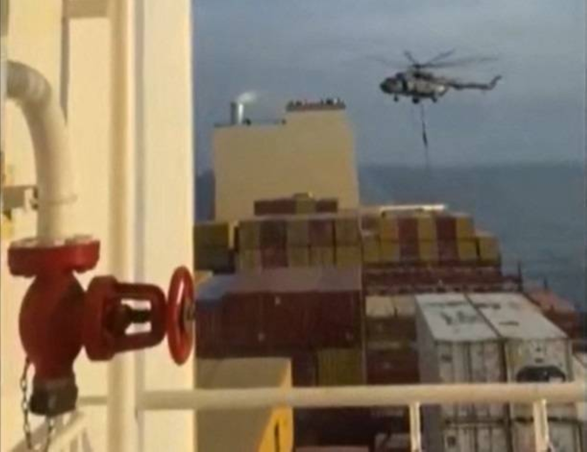 This image grab taken from a UGC video posted on social media on April 13, 2024 shows Iran's Revolutionary Guards rappelling down onto a container ship named, MSC Aries, near the Strait of Hormuz. Iran's Revolutionary Guards on Saturday seized a container ship "related to the Zionist regime (Israel) in the Gulf," state media reported, as tensions soar in the region. AFP PHOTO / XGTY