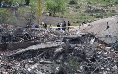 People gather around a destroyed building targeted by Israeli air strikes on the village of Nabi Sheet in the Baablbek district in Lebanon's eastern Bekaa Valley on April 14, 2024, as tensions in the region soared after Iran directly attacked Israel. AFP PHOTO