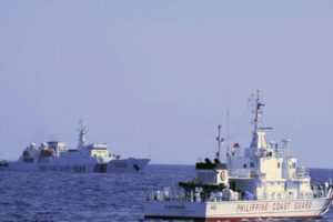 In this photo provided by the Philippine Coast Guard, a Chinese Coast Guard ship sails near a Philippine Coast Guard vessel during its patrol at Bajo de Masinloc, 124 nautical miles west of Zambales province, northwestern Philippines on March 2, 2022. A Chinese coast guard ship last month maneuvered for days near a research vessel deployed by Philippine and Taiwanese scientists to undertake a crucial survey of undersea fault lines west of the northern Philippines, sparking concerns among the scientists on board, officials said Thursday, April 7, 2022. Philippine Coast Guard via AP