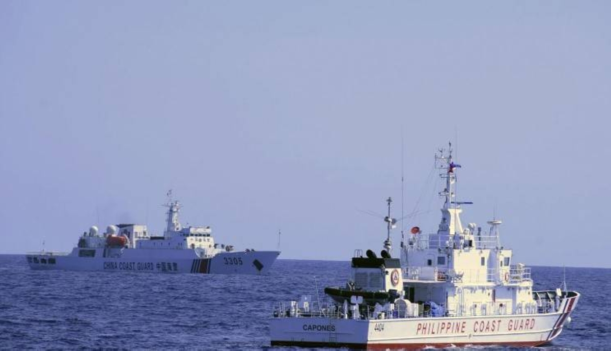 In this photo provided by the Philippine Coast Guard, a Chinese Coast Guard ship sails near a Philippine Coast Guard vessel during its patrol at Bajo de Masinloc, 124 nautical miles west of Zambales province, northwestern Philippines on March 2, 2022. A Chinese coast guard ship last month maneuvered for days near a research vessel deployed by Philippine and Taiwanese scientists to undertake a crucial survey of undersea fault lines west of the northern Philippines, sparking concerns among the scientists on board, officials said Thursday, April 7, 2022. Philippine Coast Guard via AP