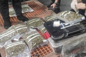 NOT HIDDEN ENOUGH Airport officials inspect the contraband. Contributed photo