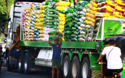 Workers unload sacks of rice from a delivery truck in Tondo, Manila on January 22, 2024. PHOTO BY MIKE ALQUINTO