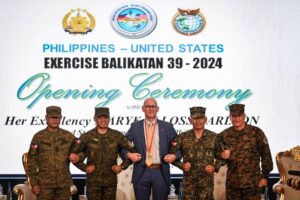 (From Left to Right) Philippines exercise director for Balikatan Major General Marvin Licudine, Armed Forces of the Philippines Chief of Staff General Romeo Brawner, US Embassy in the Philippines Chargé d’Affaires Robert Ewing, Armed Forces of the Philippines deputy Chief of Staff for Education, Training and Doctrine Major General Noel Beleran and US exercise director for Balikatan Lieutenant General William Jurney link arms during the opening ceremony of the 'Balikatan' joint military exercise at the military headquarters in Quezon City, suburban Manila on April 22, 2024. (Photo by JAM STA ROSA / AFP)