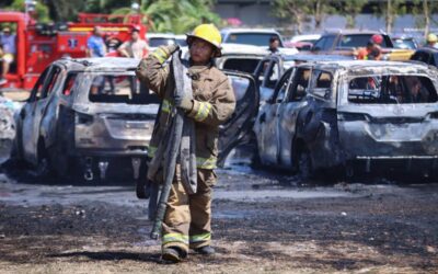 NAIA FIRE A fire fighter rests after helping put out the fire that damaged 19 vehicles at the parking area of the Ninoy Aquino International Airport Monday. Authorities attributed the conflagration to grass fire. PHOTO BY J. GERARD SEGUIA