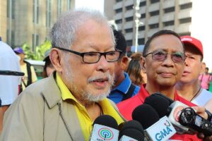 Former senator Rene Saguisag, with former vice president Jejomar Binay, talks to media before offering flowers at the monument of Ninoy Aquino in Makati City on Feb. 25, 2020.