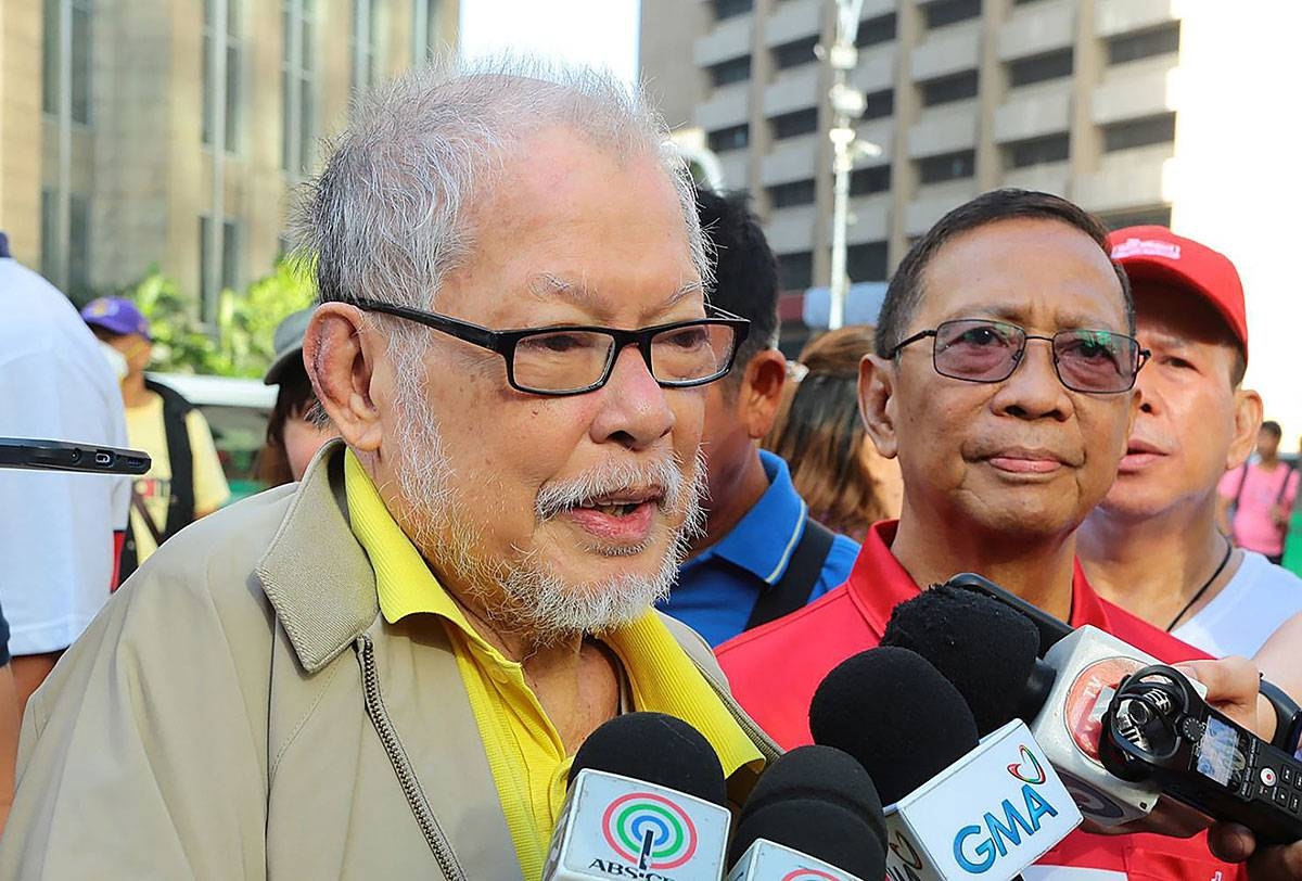 Former senator Rene Saguisag, with former vice president Jejomar Binay, talks to media before offering flowers at the monument of Ninoy Aquino in Makati City on Feb. 25, 2020.