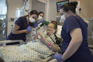 Lisa Pisano looks at photos of her dog after her surgeries at NYU Langone Health in New York on Monday, April 22, 2024. AP PHOTO