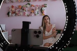 Mari Juliette, the owner of Mari Juliette Real Estate, uses her phone to give a TikTok tour of a condo she is selling on April 26, 2024, in Miami, Florida. AFP PHOTO
