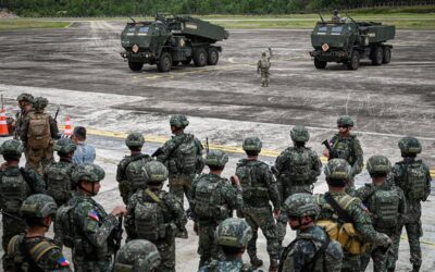 Soldiers look on as High Mobility Artillery Rocket System (HIMARS) batteries arrive for an airfield seizure exercise as part of the US-Philippines Balikatan joint military exercise at San Vicente Airport in Palawan on May 1, 2024. JAM STA ROSA / AFP