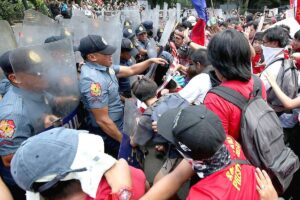 MAY FRAY Manila policemen stand their ground as Labor Day marchers attempt to get near the US Embassy in Manila on Wednesday, May1, 2024. PHOTO BY RENE H. DILAN