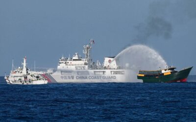 This photo taken on March 5, 2024 shows China Coast Guard vessels deploying water cannons at the Philippine military chartered Unaizah May 4 (R) during its supply mission to Second Thomas Shoal in disputed waters of the South China Sea.  JAM STA ROSA / AFP