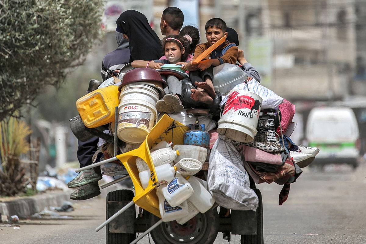 A man, woman, and children ride in the back of a tricycle loaded with belongings and other items as they flee bound for Khan Yunis, in Rafah in the southern Gaza Strip on May 11, 2024 amid the ongoing conflict in the Palestinian territory between Israel and Hamas.
AFP