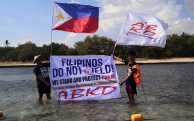 Fisherfolk from Zambales, along with Alyansa Bantay Kapayapaan at Demokrasya, wave a Philippine flag during a fluvial parade in the West Philippine Sea in Candelaria, Zambales, on Saturday, May 11, 2024, to express their condemnation of the harassment by the Chinese Coast Guard of Filipino fishermen. PHOTOS BY ISMAEL DE JUAN