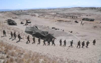 US Marines walk down a sand dune after a live fire exercise against an imaginary "invasion" force as part of the joint US-Philippines annual military Balikatan drills in Laoag on Luzon island's northwest coast on May 6, 2024. US and Filipino troops fired missiles and artillery at an imaginary "invasion" force during war games on the Philippines' northern coast on May 6, days after their governments objected to China's "dangerous" actions in regional waters. Ted ALJIBE / AFP