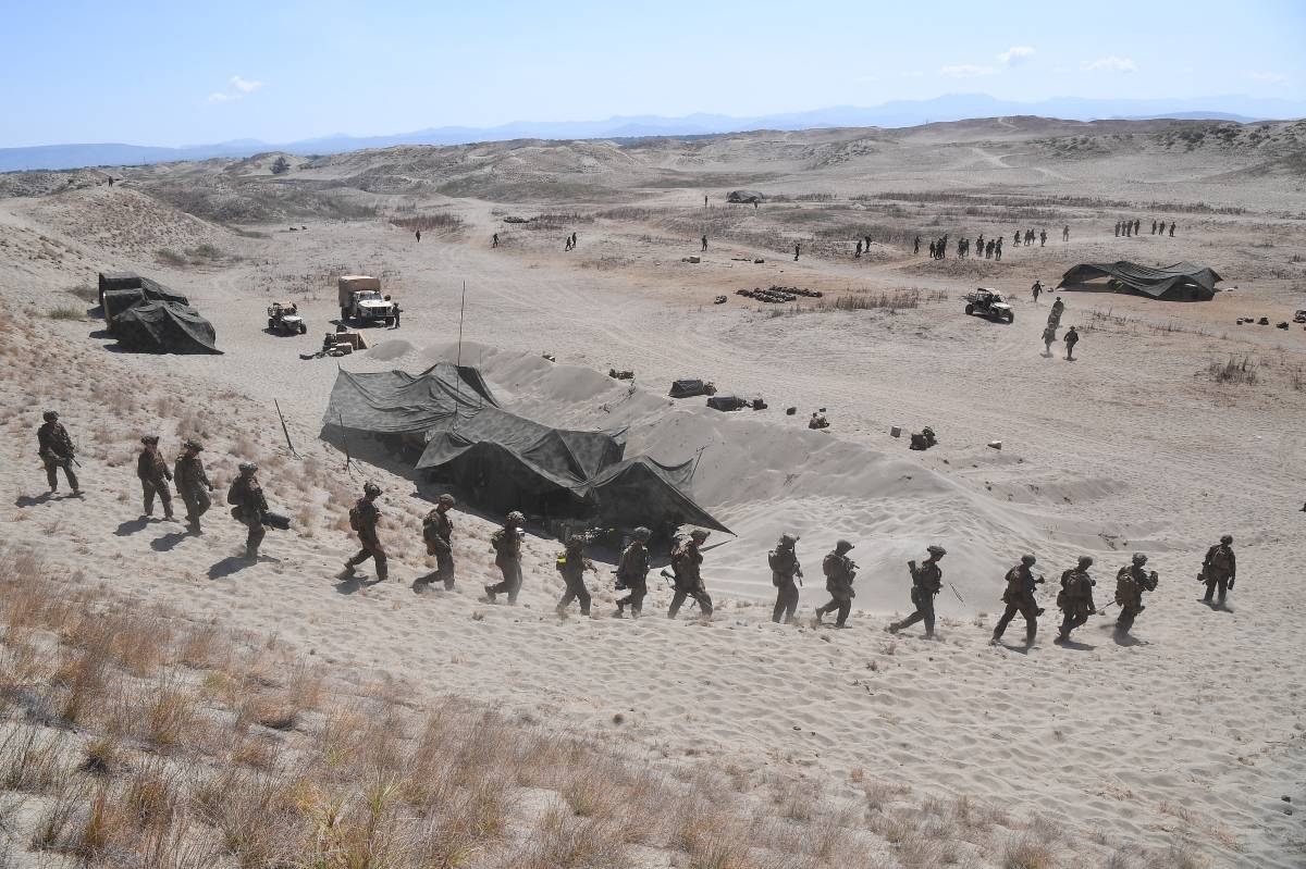 US Marines walk down a sand dune after a live fire exercise against an imaginary "invasion" force as part of the joint US-Philippines annual military Balikatan drills in Laoag on Luzon island's northwest coast on May 6, 2024. US and Filipino troops fired missiles and artillery at an imaginary "invasion" force during war games on the Philippines' northern coast on May 6, days after their governments objected to China's "dangerous" actions in regional waters. Ted ALJIBE / AFP