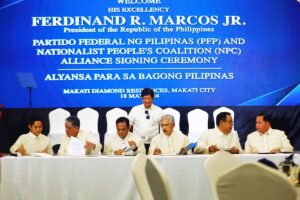 NEW ALLIANCE President Ferdinand Marcos Jr. (standing) witnesses the signing of an alliance between his Partido Federal ng Pilipinas and the Nationalist People’s Coalition, led by its chairman and former Senate president Vicente Sotto III in Makati on May 18, 2024. South Cotabato Gov. Reynaldo Tamayo Jr. represented PFP as its president. Seated (from left) are llocos Norte 1st District Rep. Ferdinand Alexander Marcos, Special Assistant to the President Antonio Lagdameo Jr., Tamayo, Sotto, Rizal 1st District Rep. Michael John Duavit, and Secretary Mark Llandro Mendoza, presidential adviser on legislative affairs and head of the presidential legislative liaison office. PHOTO BY MIKE ALQUINTO