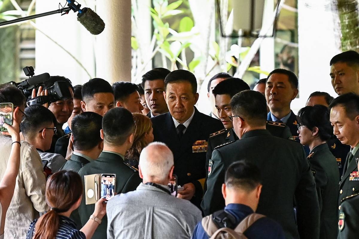 China's Defence Minister Dong Jun (C) is surrounded by media and his delegation after a bilateral meeting with US Secretary of Defence Lloyd Austin on the sidelines of the 21st Shangri-La Dialogue summit at the Shangri-La Hotel in Singapore on May 31, 2024. The US and Chinese defence chiefs held rare direct talks in Singapore on May 31, offering hopes for more military dialogue that could help prevent disputes over Taiwan and other flashpoint issues from spinning out of control. Photo by NHAC NGUYEN / AFP